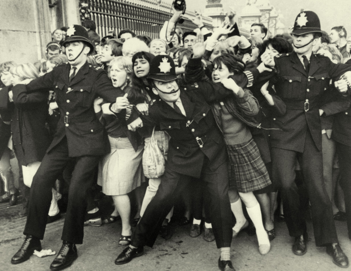 A mob of women from the mid 1900s being held back by London bobbies to symbolise health food trends