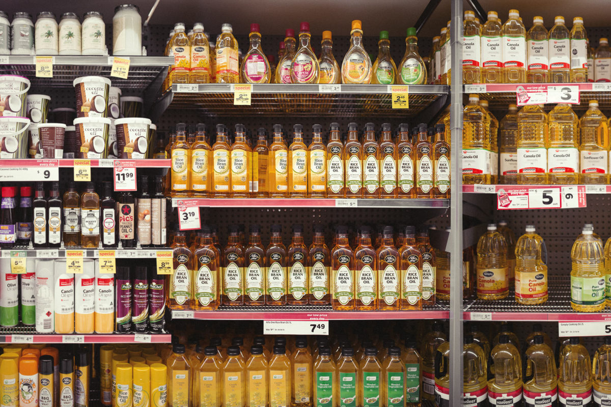 A large array of plant oils in a supermarket to indicate why omega 6 is bad for you