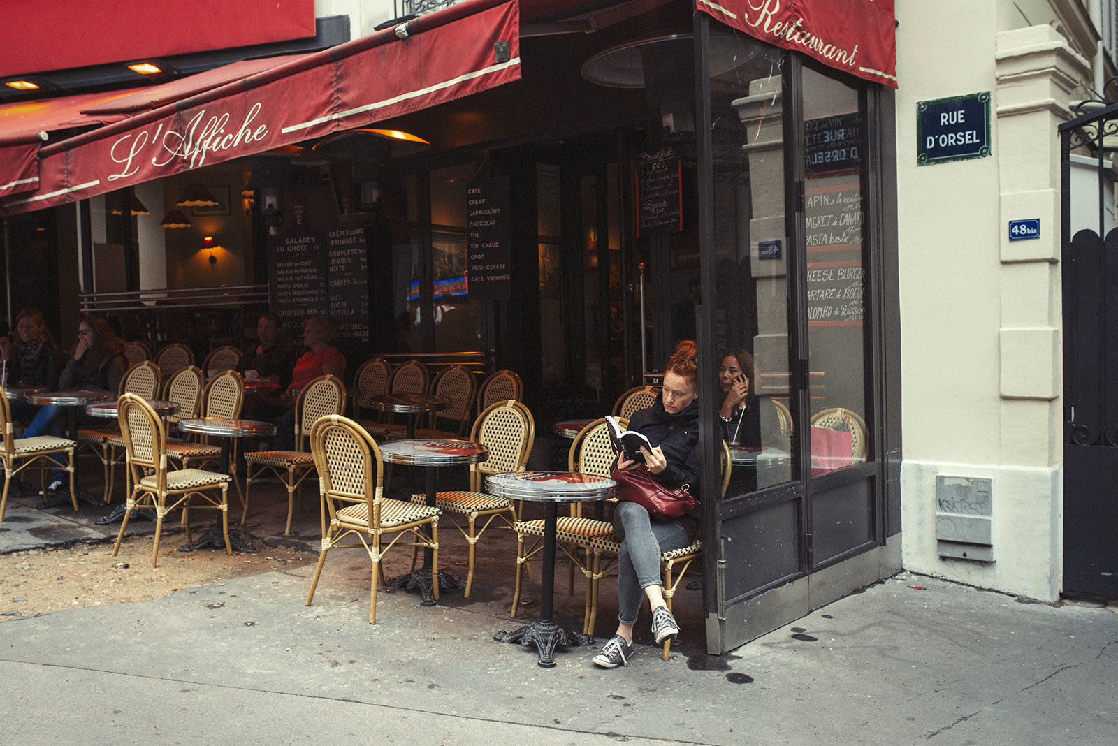 Naturopath Lisa Fitzgibbon sat at a Paris cafe enjoying a minimalist lifestyle